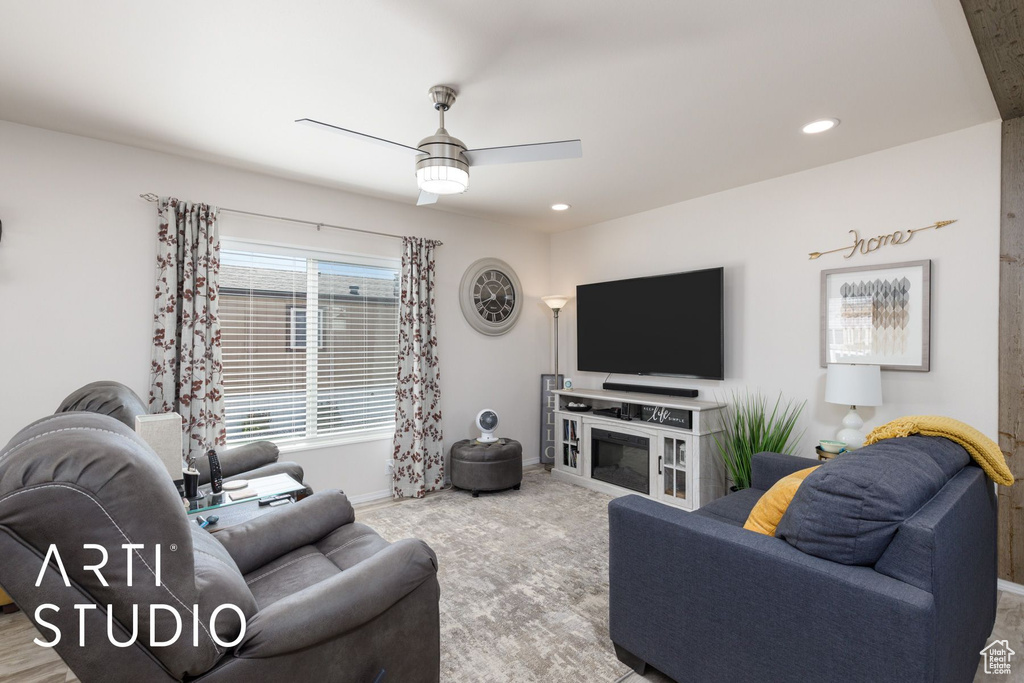 Living room with a ceiling fan and recessed lighting