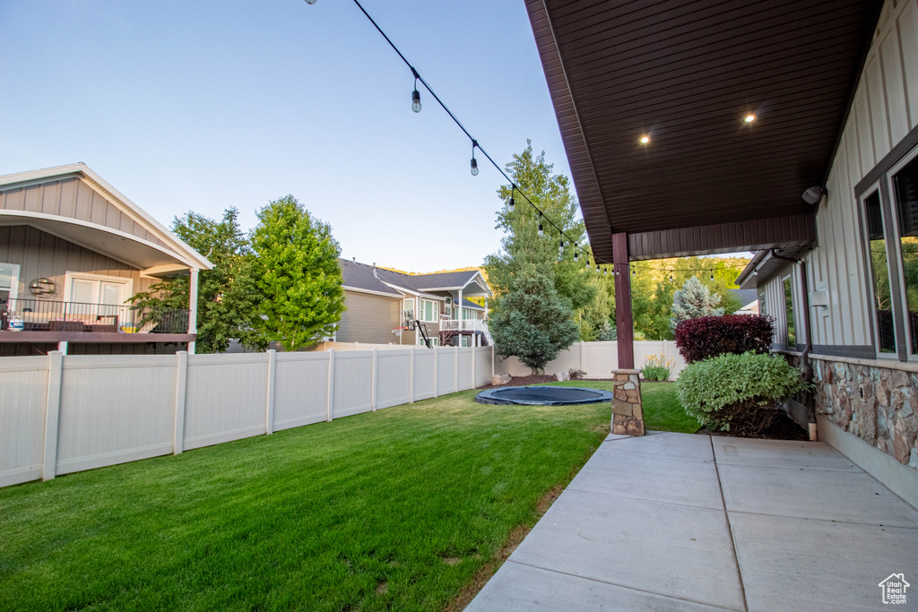 Fenced backyard with a patio area