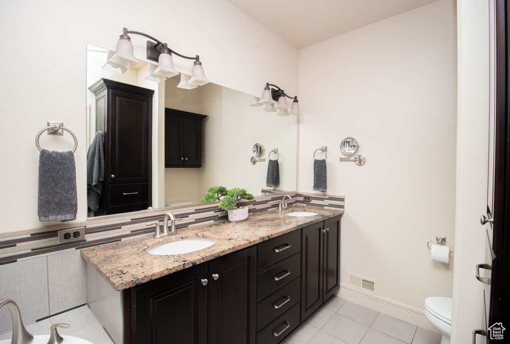Full bathroom with double vanity and tile patterned flooring