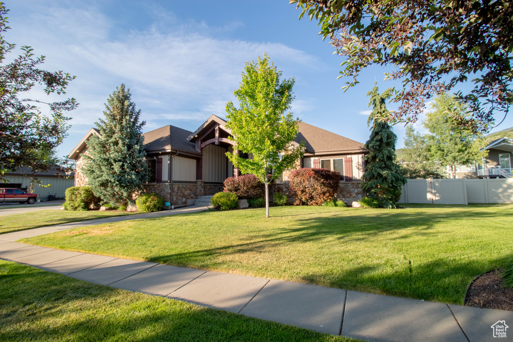 View of front of property with stone siding and board and batten siding