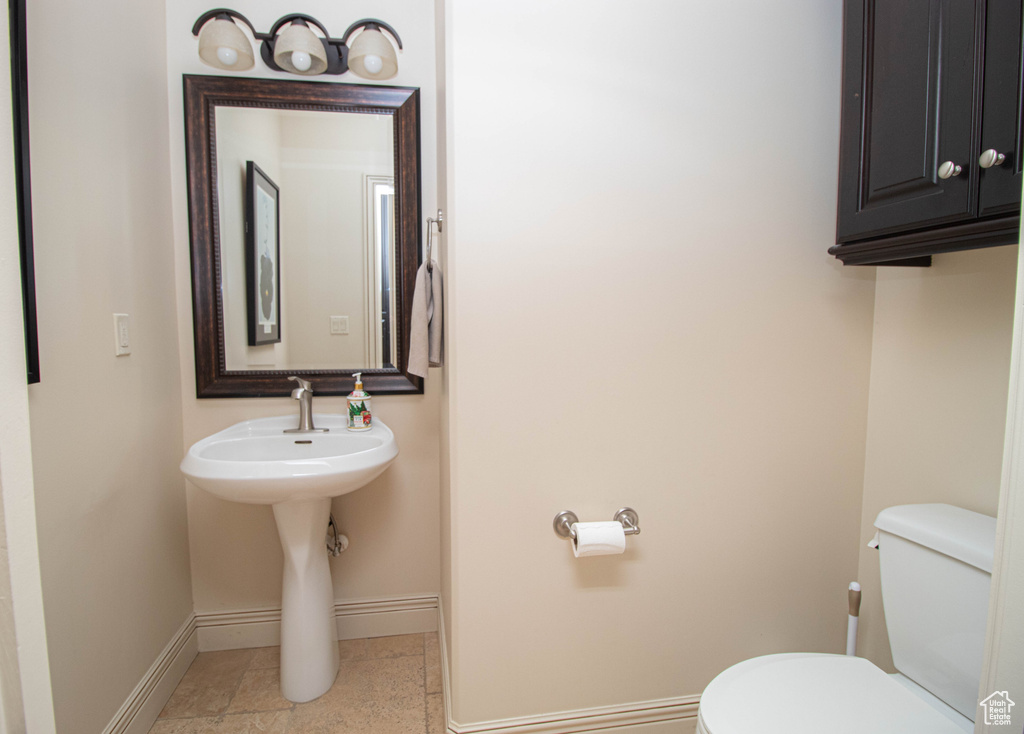 Bathroom featuring baseboards and toilet