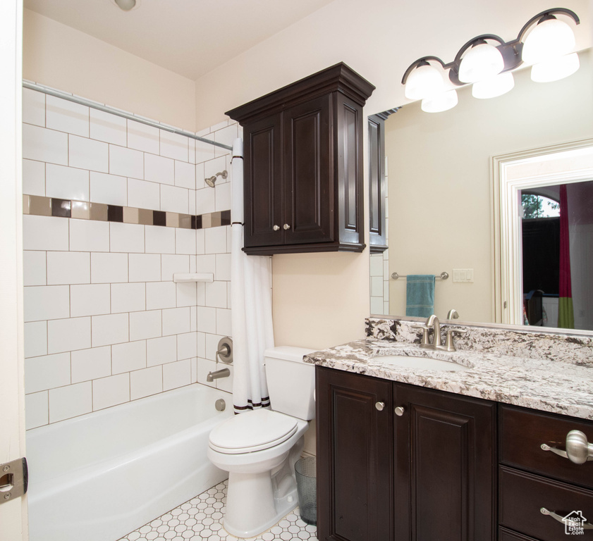 Bathroom with shower / tub combo with curtain and vanity