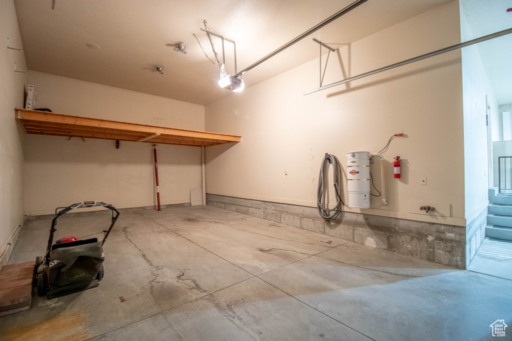 Garage with a garage door opener and a central vacuum unit