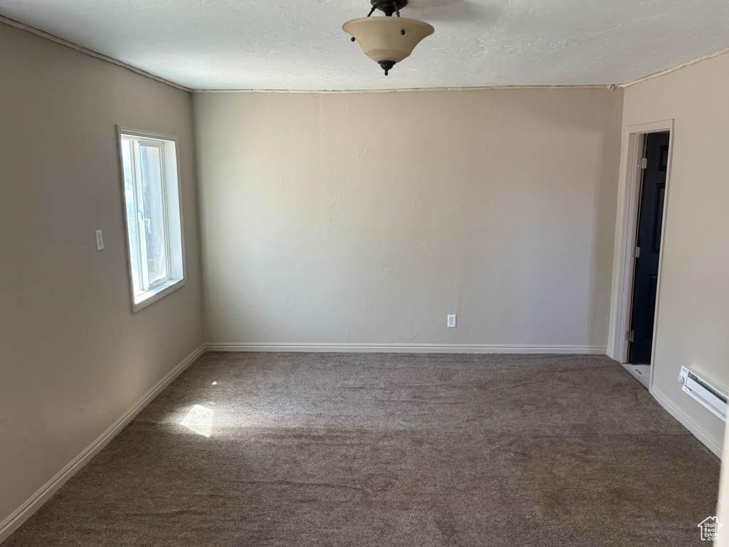 Empty room with carpet flooring and baseboards