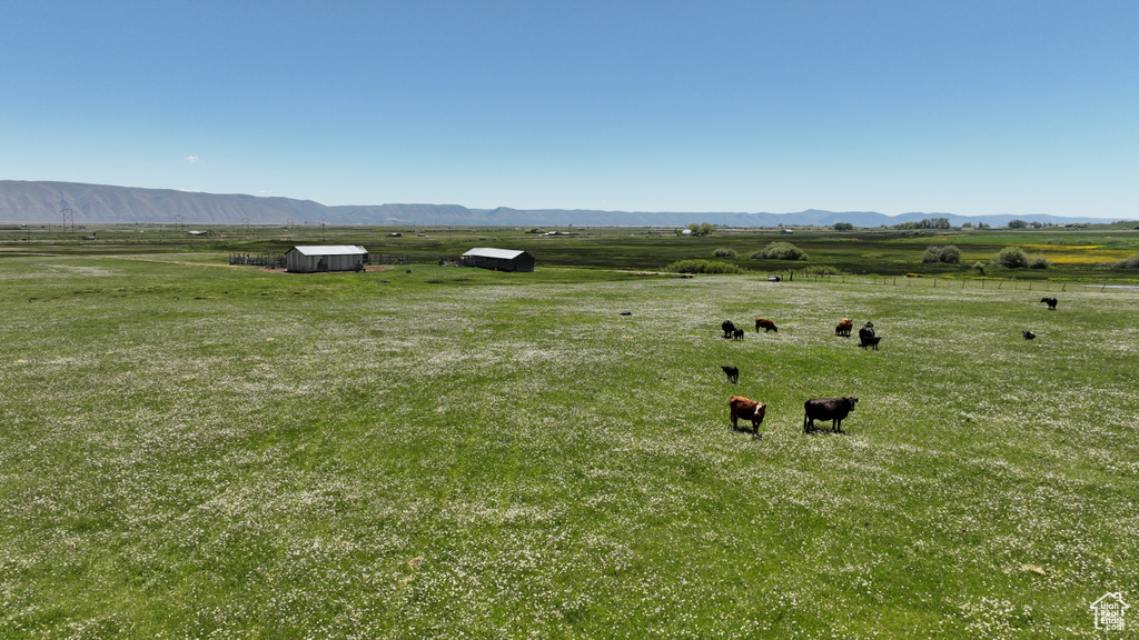 View of mountain backdrop featuring rural landscape and agricultural land