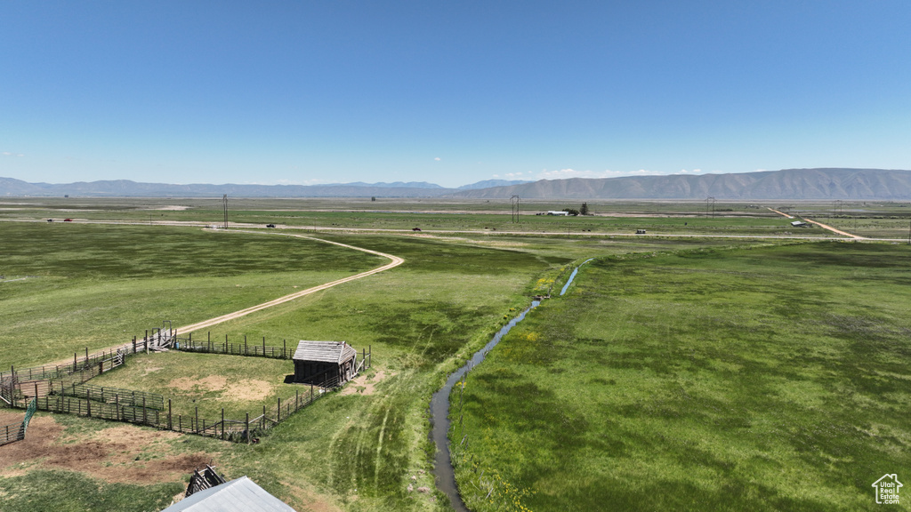 View of rural area with a pastoral area and a mountain backdrop