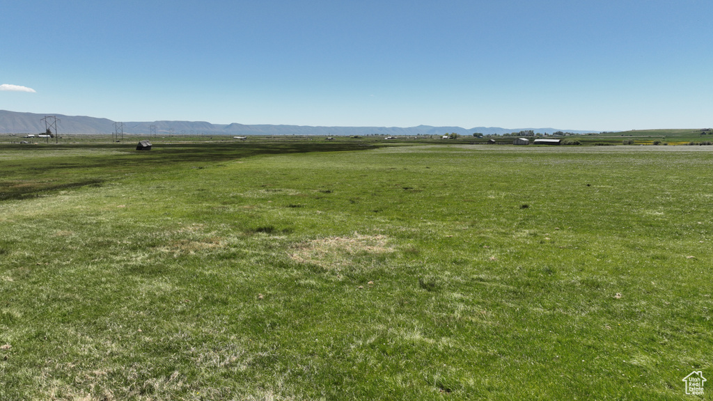 View of green lawn featuring a view of rural / pastoral area and a mountain view