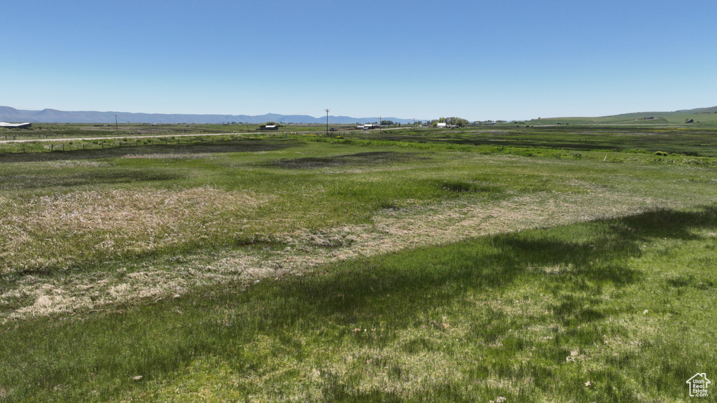View of yard featuring a view of rural / pastoral area and a mountain view