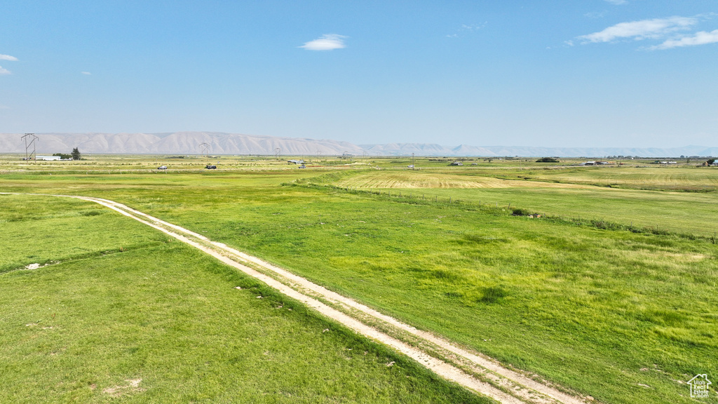 View of yard with a rural view and a mountain view