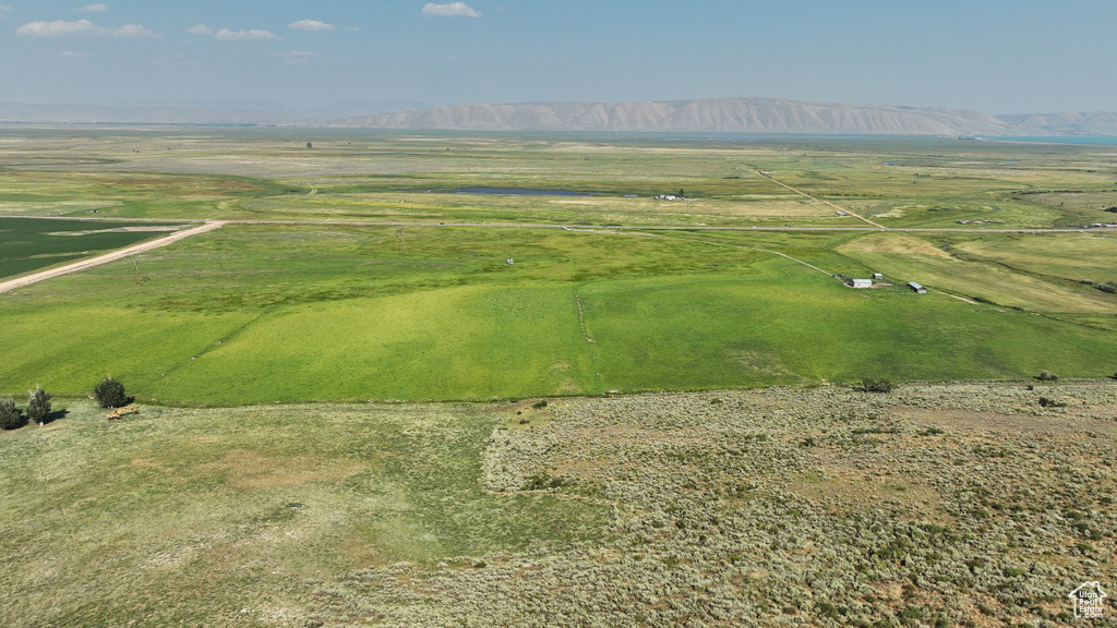 Aerial view of property and surrounding area featuring a mountain backdrop