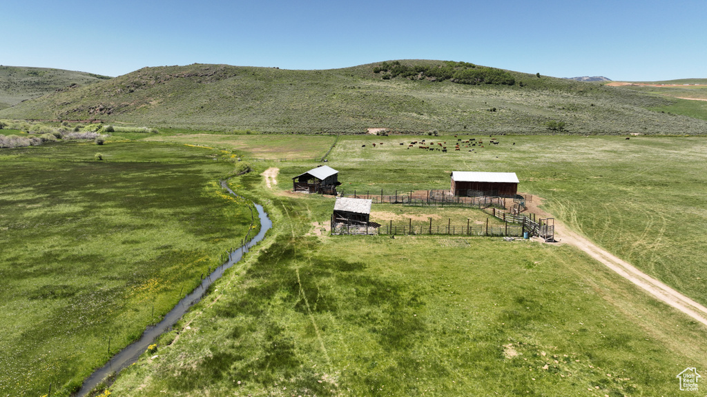 View of mountain backdrop featuring rural landscape and agricultural land