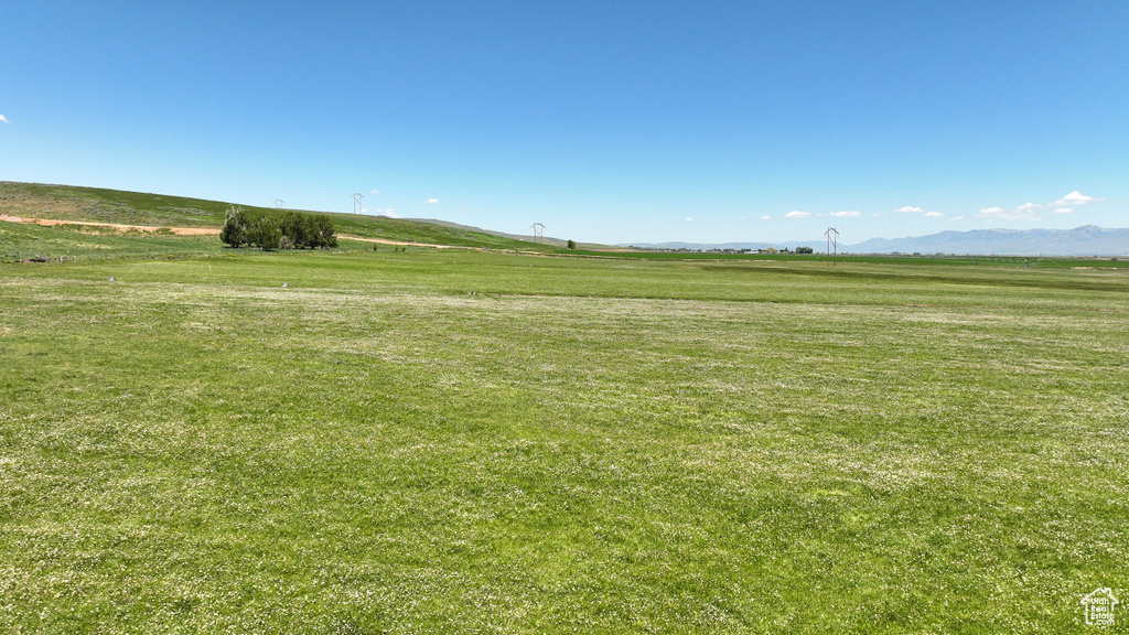 View of green lawn featuring a view of rural / pastoral area and a mountain view