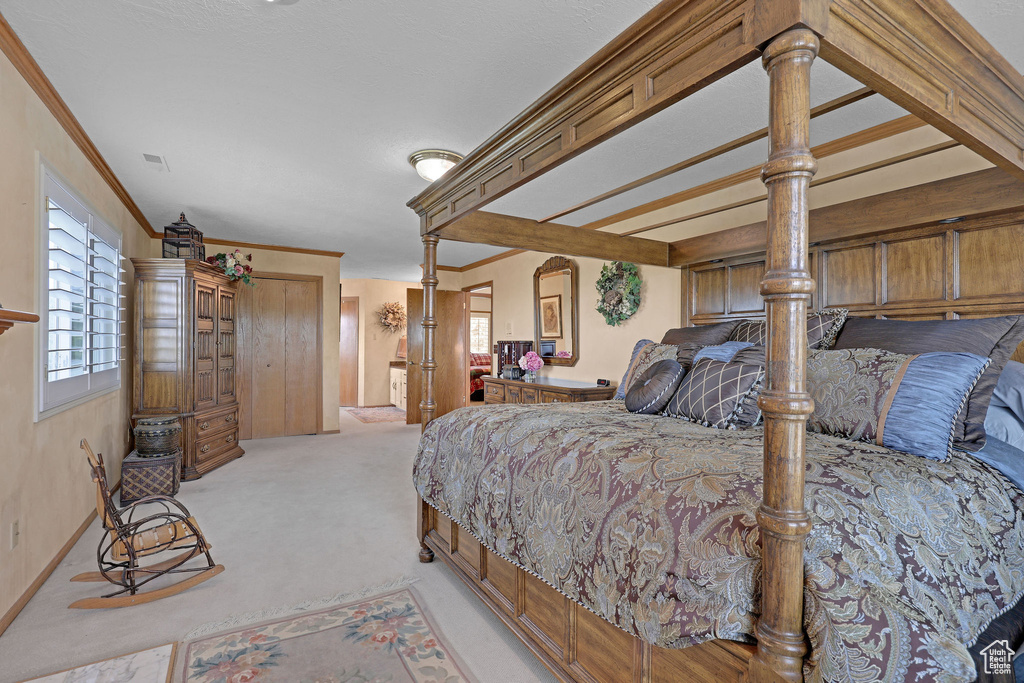Bedroom featuring light carpet and ornamental molding