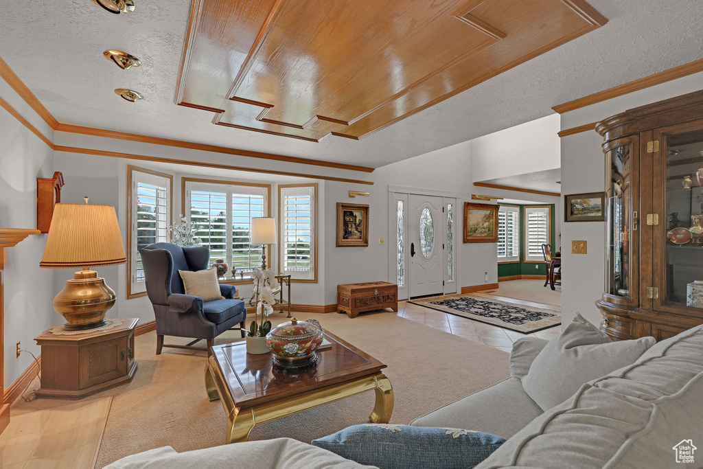 Tiled living area with crown molding and a textured ceiling
