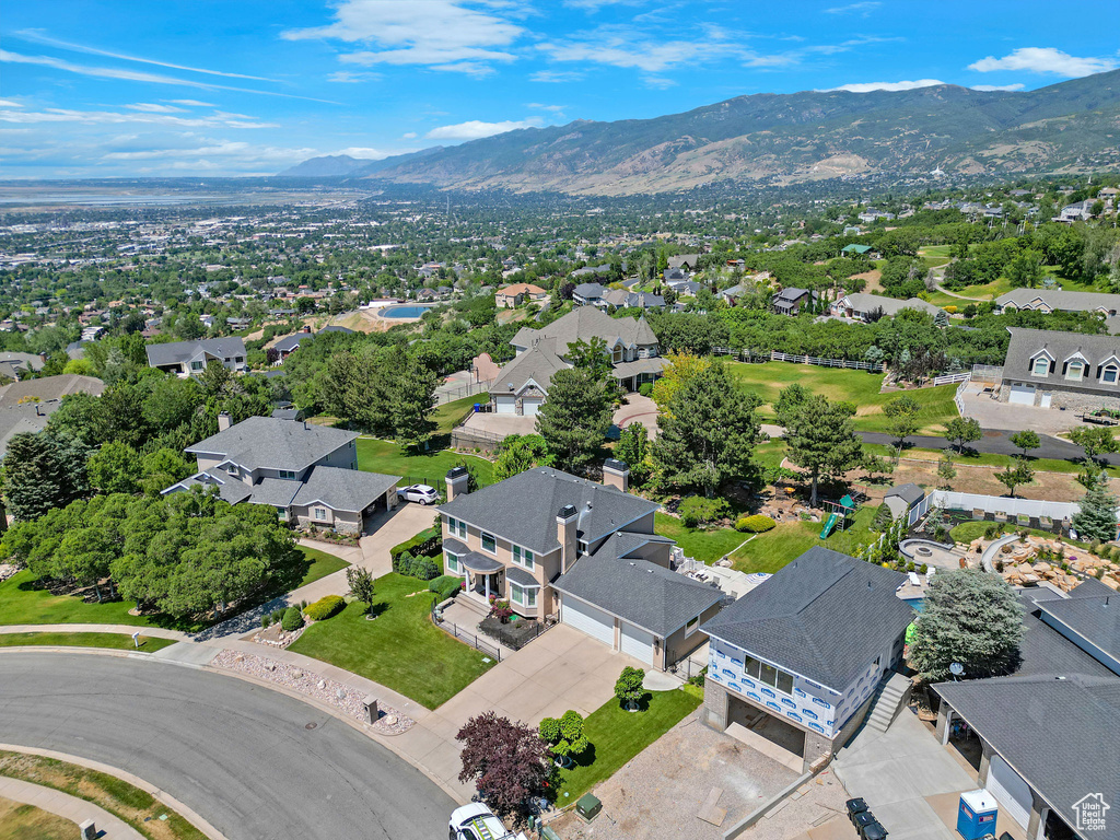 Aerial perspective of suburban area featuring a mountainous background