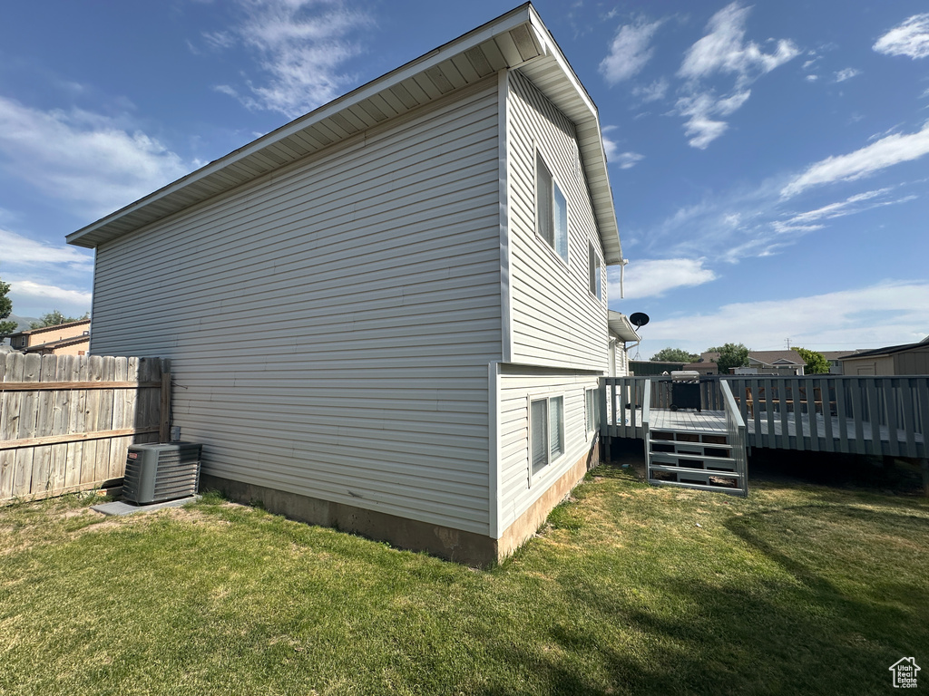 View of property exterior with a central air condition unit and a deck