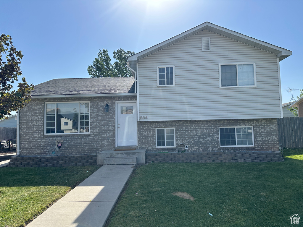 Tri-level home featuring brick siding