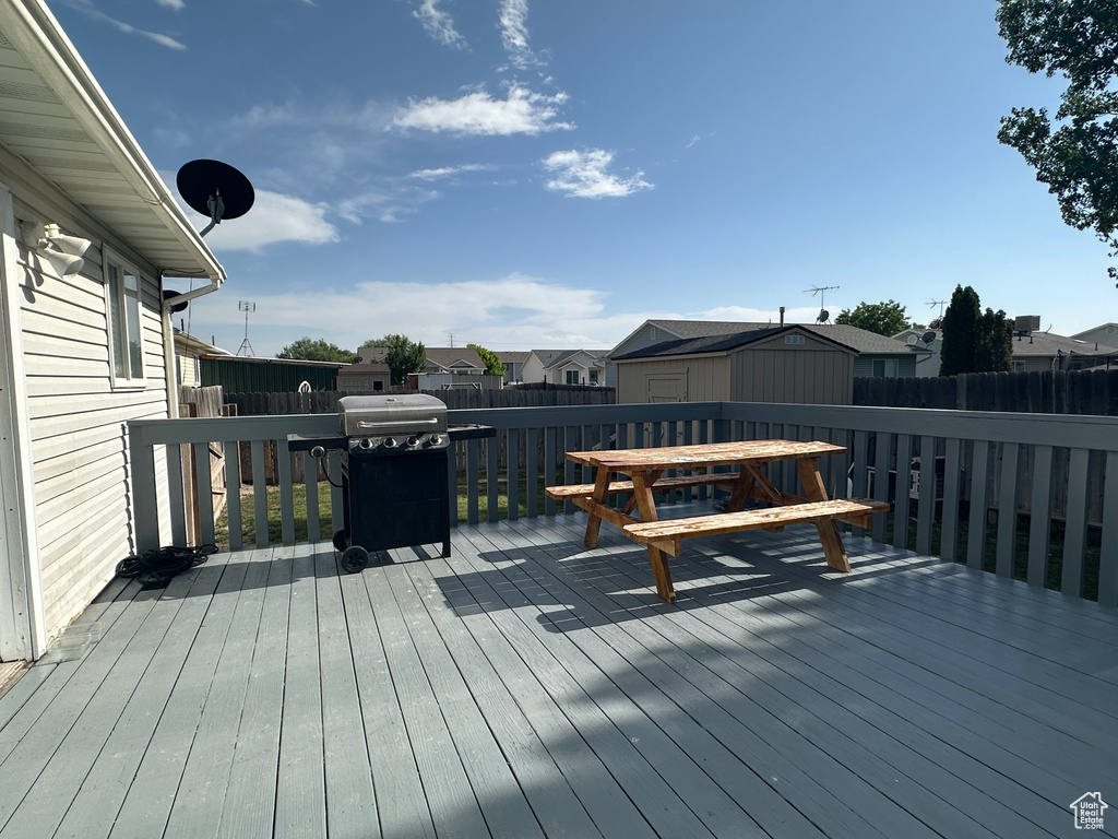 Wooden deck with a residential view and a grill