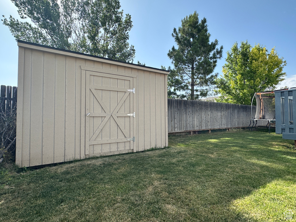 View of shed with a fenced backyard