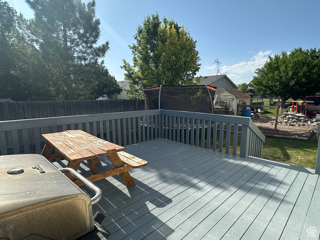 Wooden terrace featuring a fenced backyard and outdoor dining area