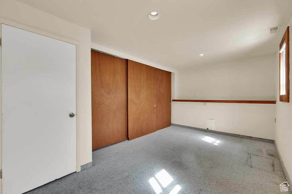 Unfurnished bedroom featuring recessed lighting, a closet, and carpet