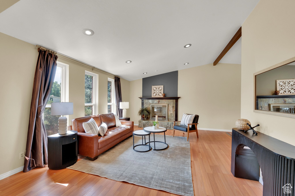 Living room featuring wood finished floors, a fireplace, and recessed lighting