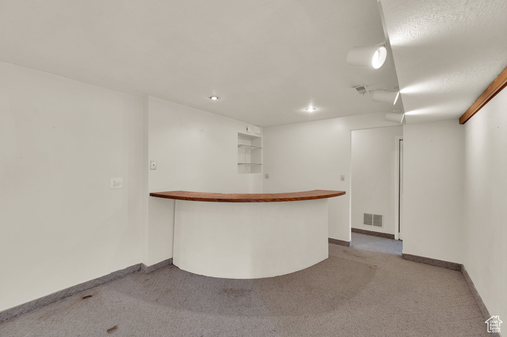 Indoor dry bar featuring carpet flooring and recessed lighting