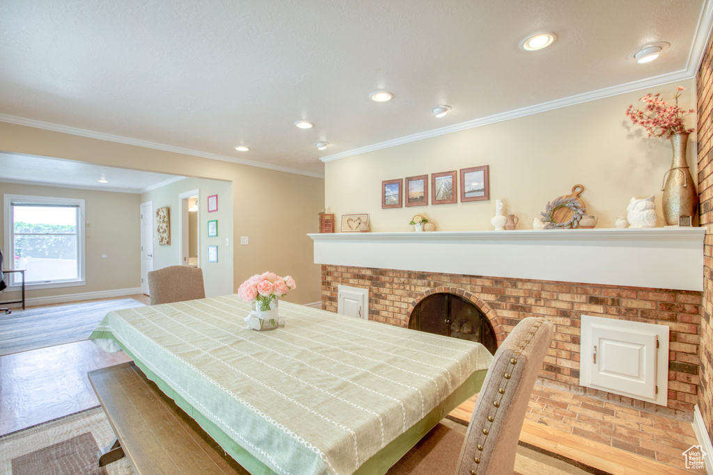 Dining room with recessed lighting, light wood-style floors, and ornamental molding