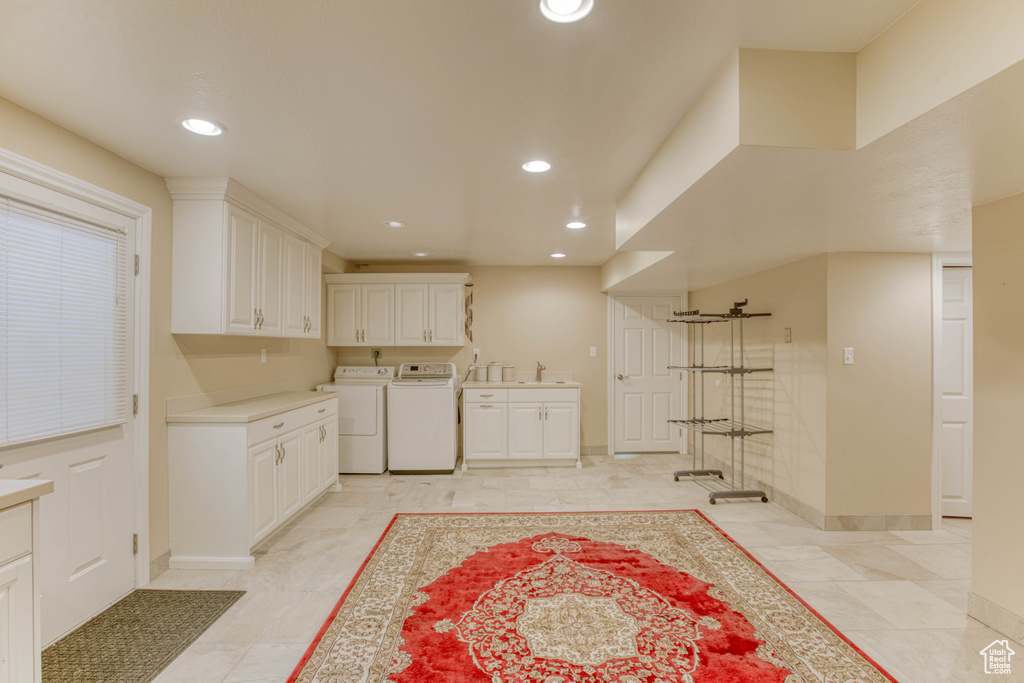 Kitchen with separate washer and dryer, white cabinets, recessed lighting, and light countertops