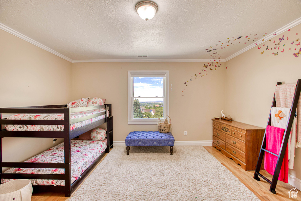 Bedroom featuring crown molding and a textured ceiling