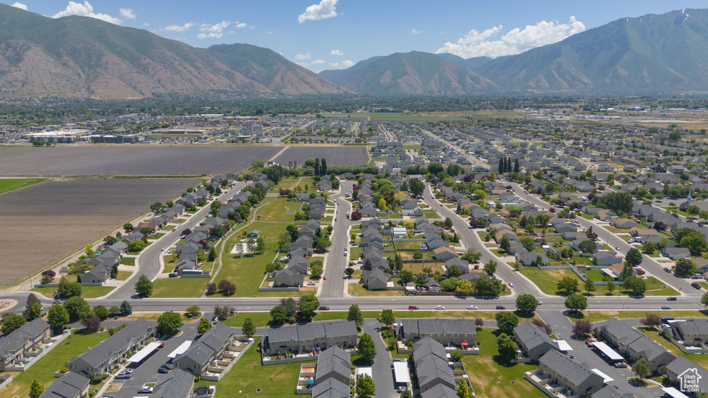 Aerial view of property's location with nearby suburban area and a mountain backdrop