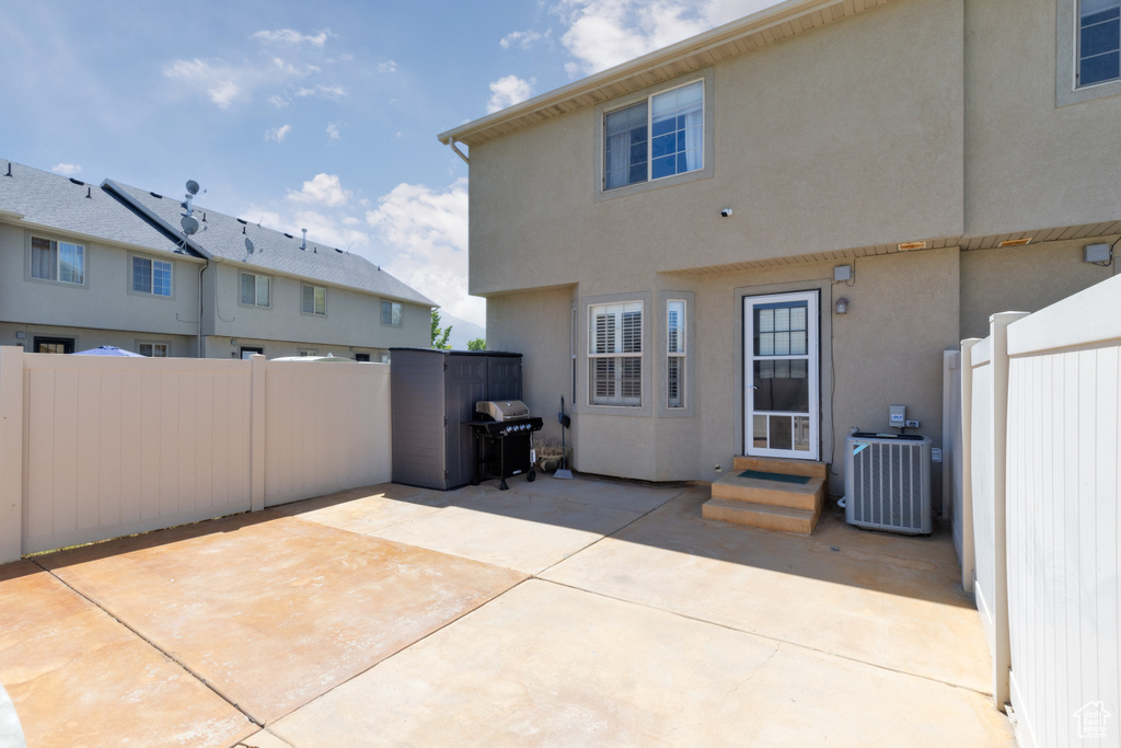 Back of house with entry steps, a patio, and stucco siding