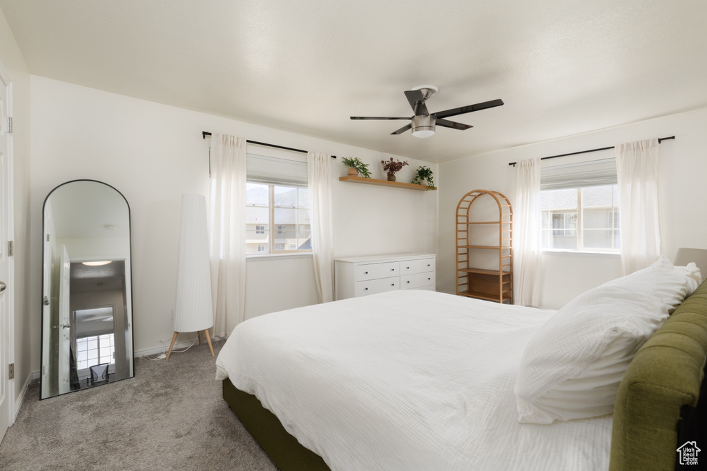 Bedroom with light carpet and ceiling fan