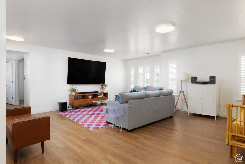 Living room featuring light wood-style floors and baseboards