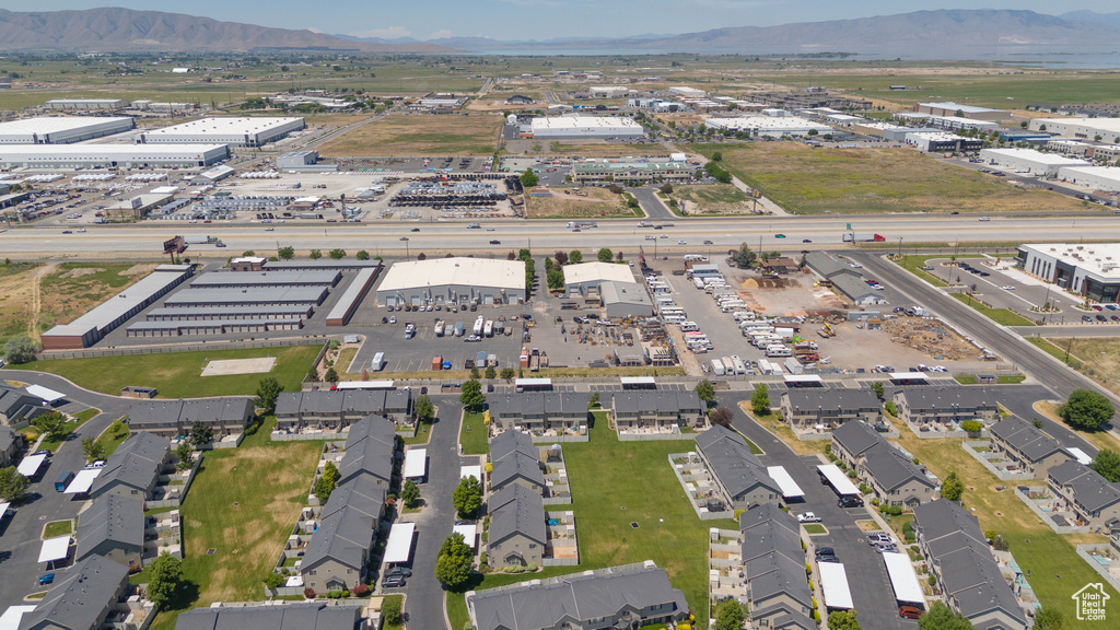 Aerial view of property and surrounding area with an industrial area and mountains