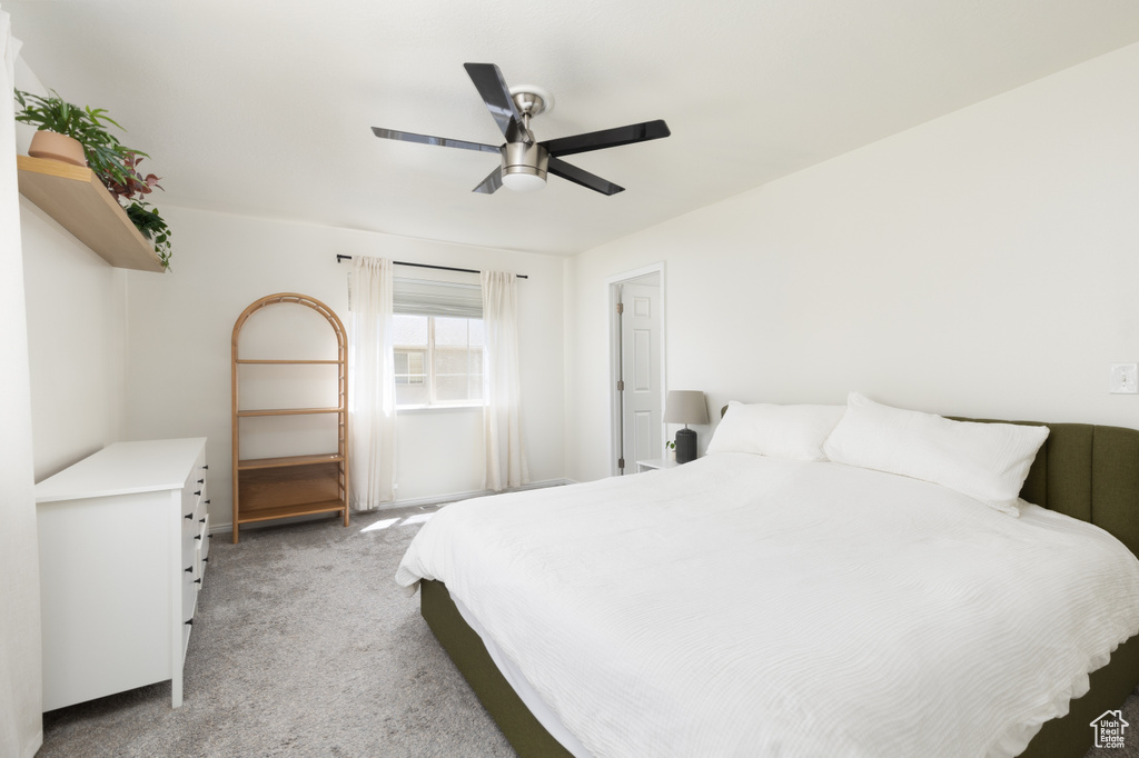 Bedroom featuring light colored carpet and ceiling fan