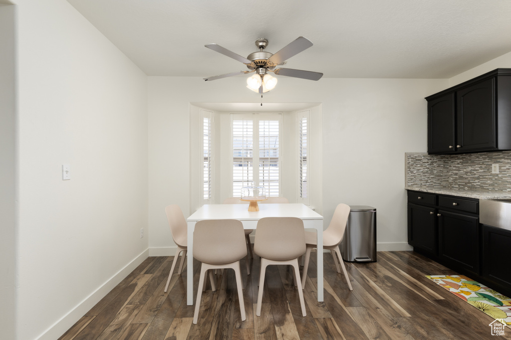 Dining space featuring dark wood-style flooring and a ceiling fan