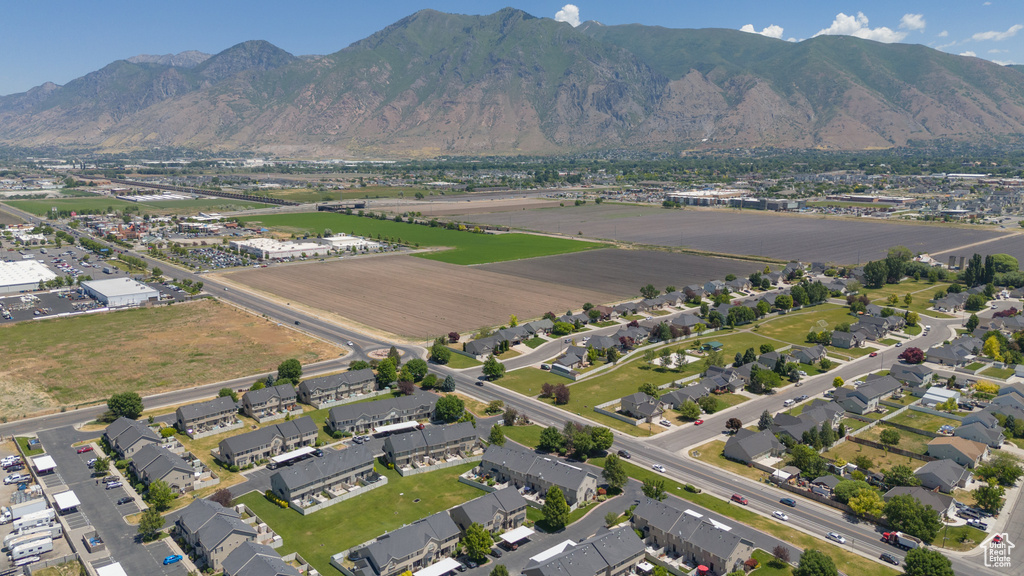 Aerial view of property's location with mountains and nearby suburban area
