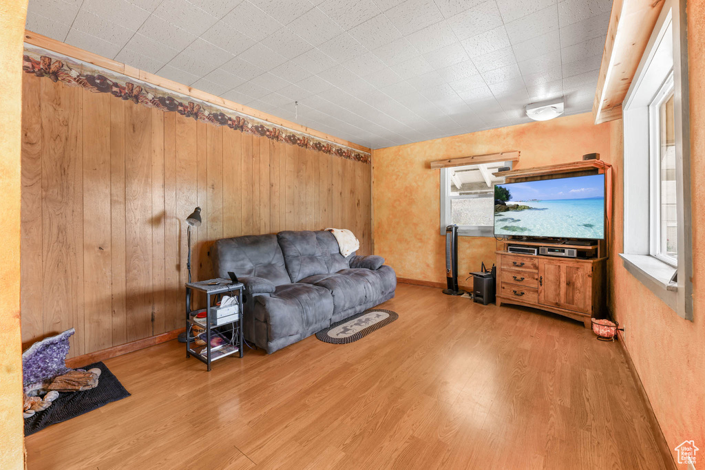 Living area featuring wood finished floors and wood walls