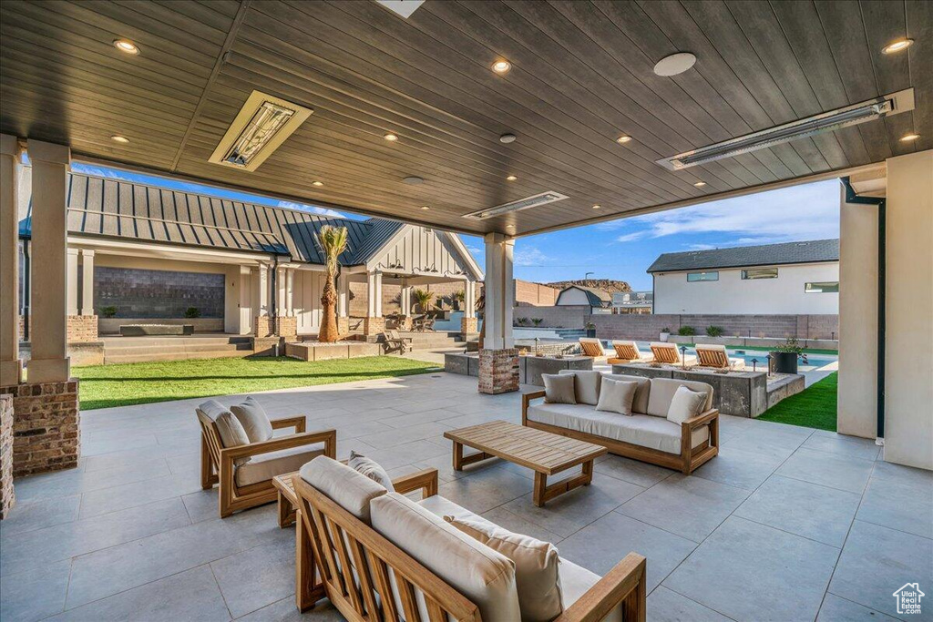 View of patio featuring an outdoor living space with a fire pit