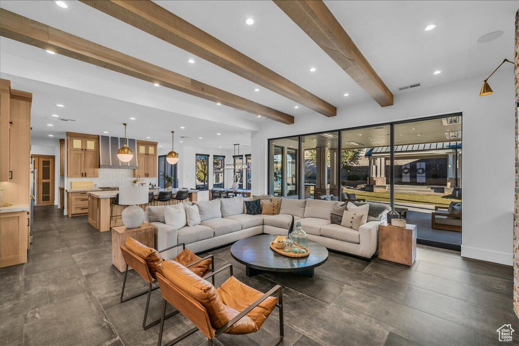 Living area with beam ceiling and recessed lighting