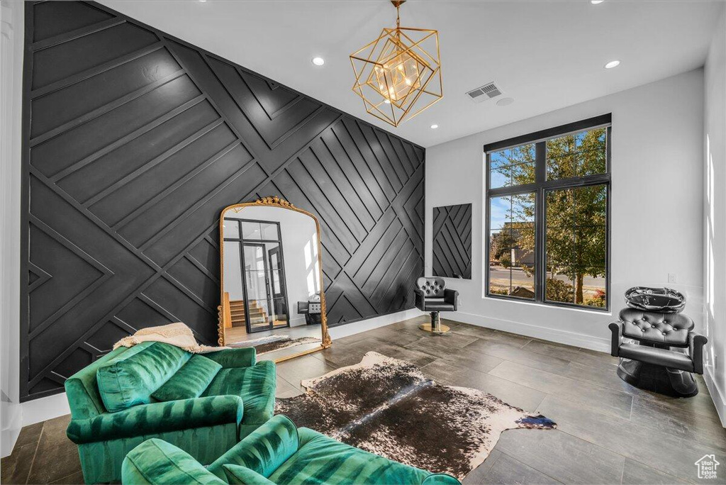 Sitting room with a chandelier, recessed lighting, wood finished floors, and an accent wall
