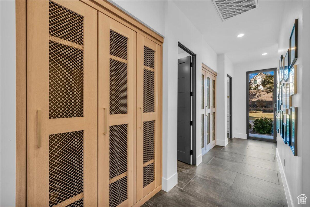 Corridor featuring baseboards and recessed lighting