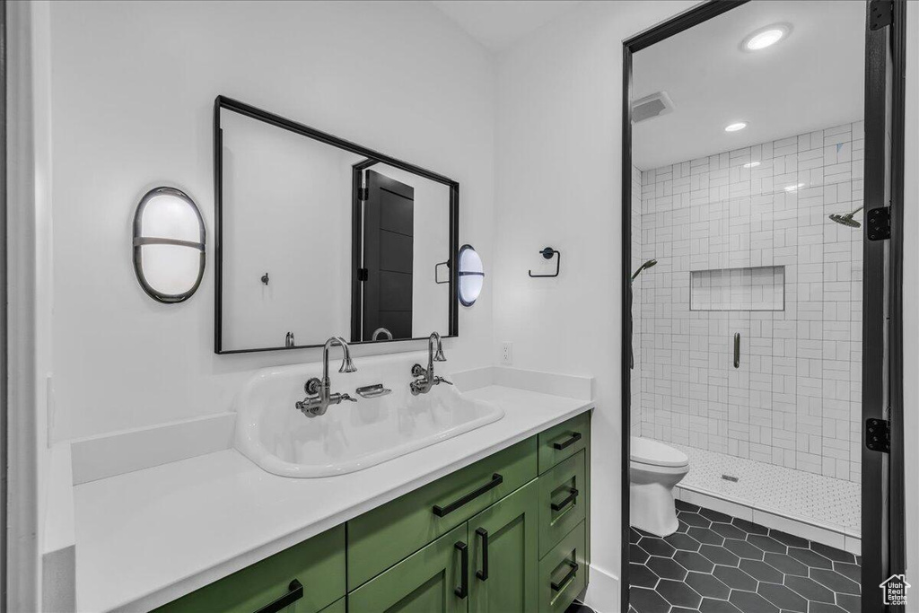 Bathroom featuring vanity, a shower stall, and recessed lighting