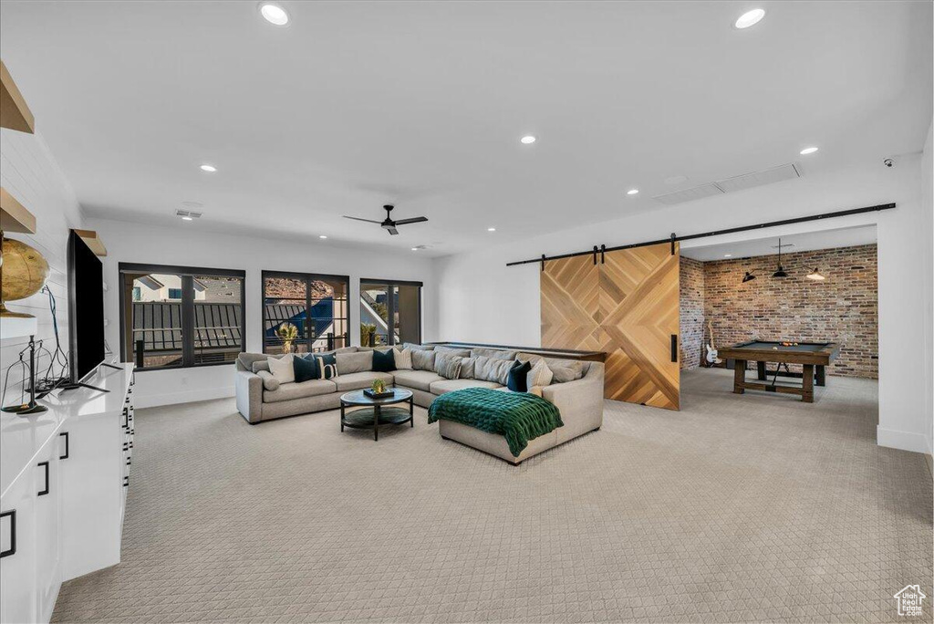 Carpeted living room with recessed lighting, ceiling fan, and billiards