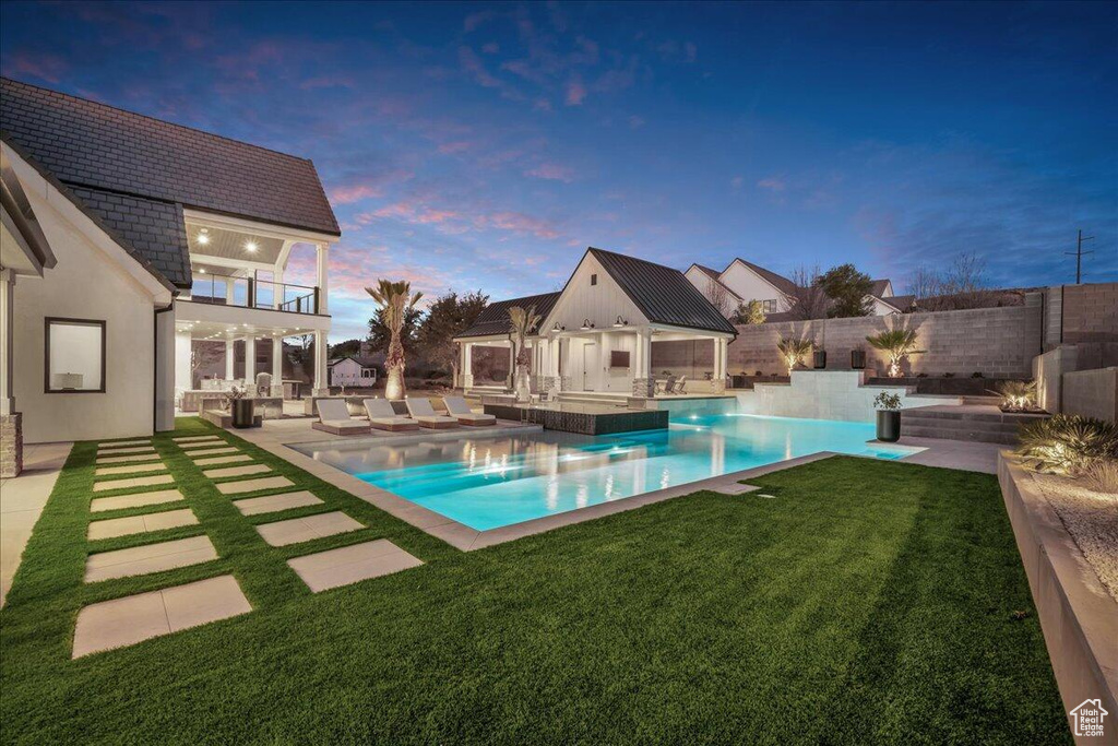 View of pool featuring an outbuilding, a patio, a fenced backyard, and outdoor lounge area