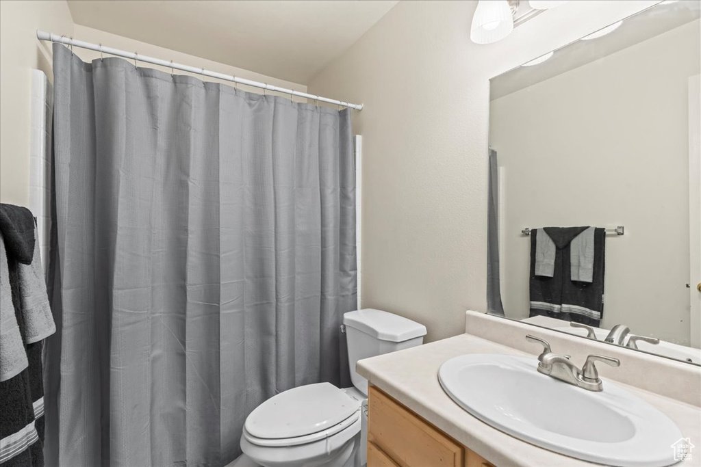 Full bath with vanity and a shower with curtain