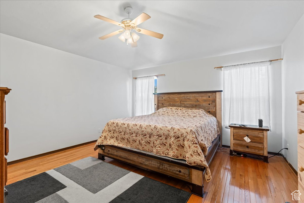 Bedroom with hardwood / wood-style flooring and a ceiling fan