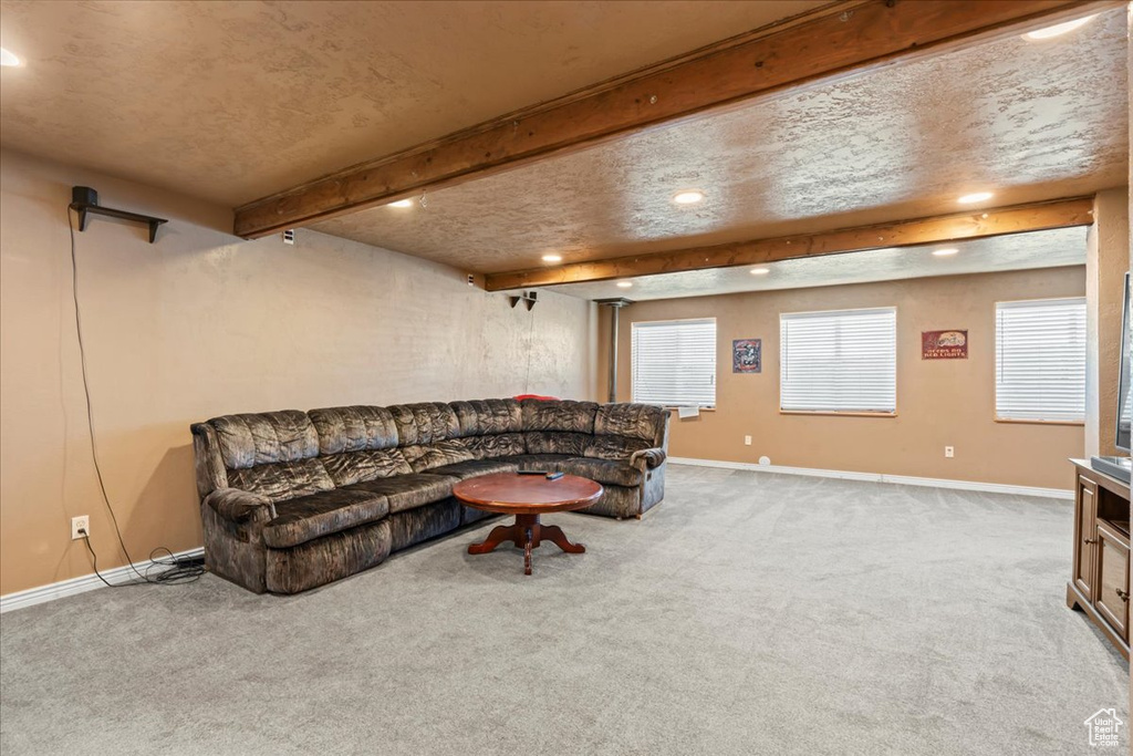 Living area featuring recessed lighting, carpet, and beam ceiling