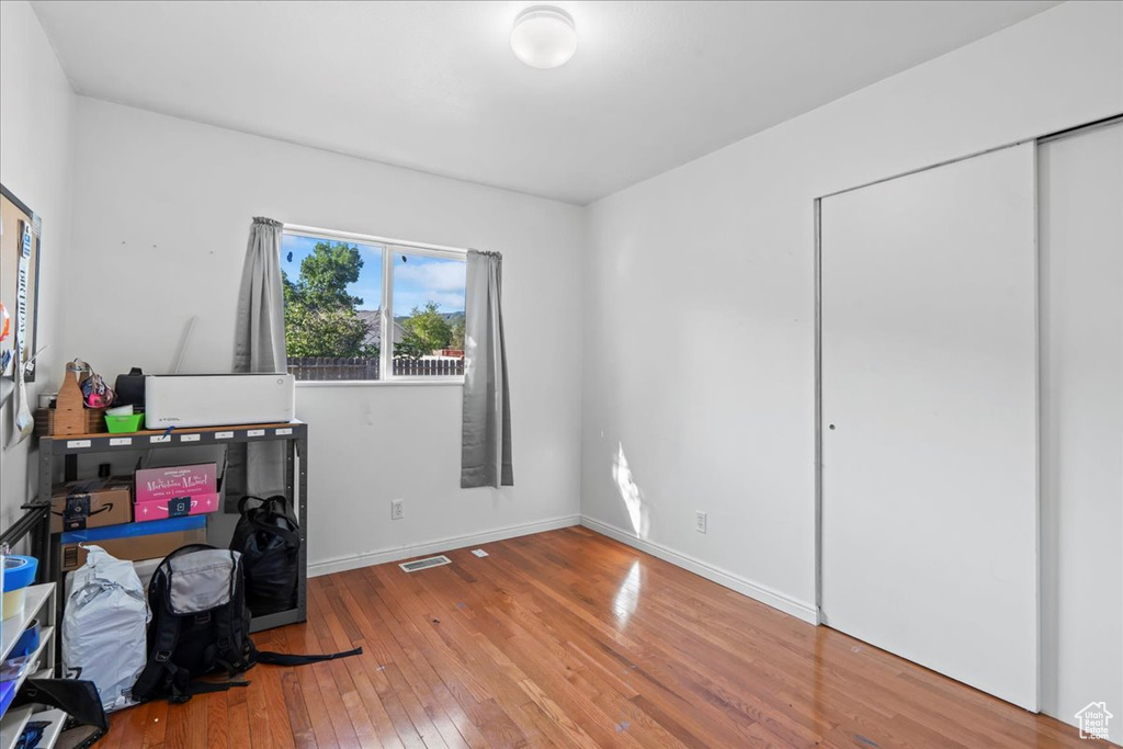 Home office featuring hardwood / wood-style flooring and baseboards